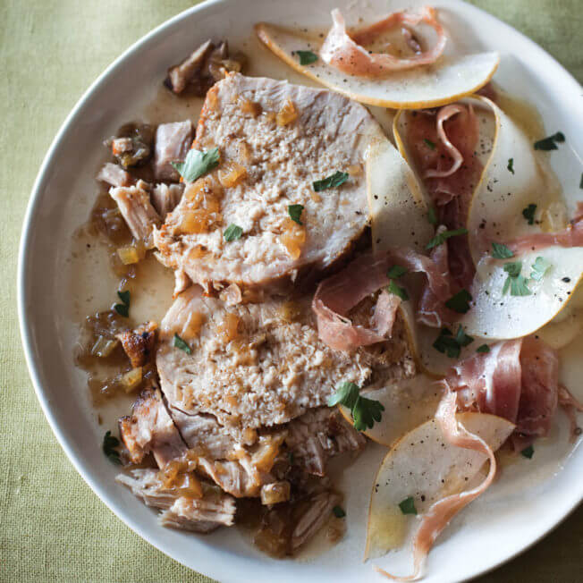 Tangy braised pork loin with pear and prosciutto salad